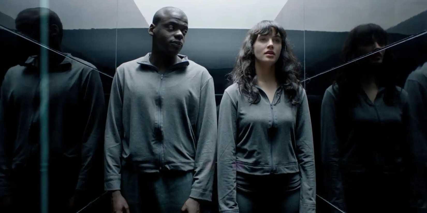 Bing and Abi stand beside each other in the Black Mirror episode Fifteen Million Merits.