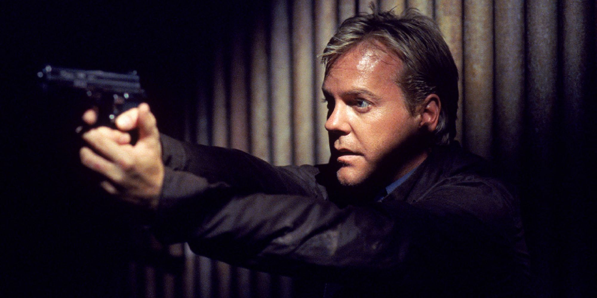 Jack Bauer, played by Kiefer Sutherland, pointing a gun in the first season of 24.