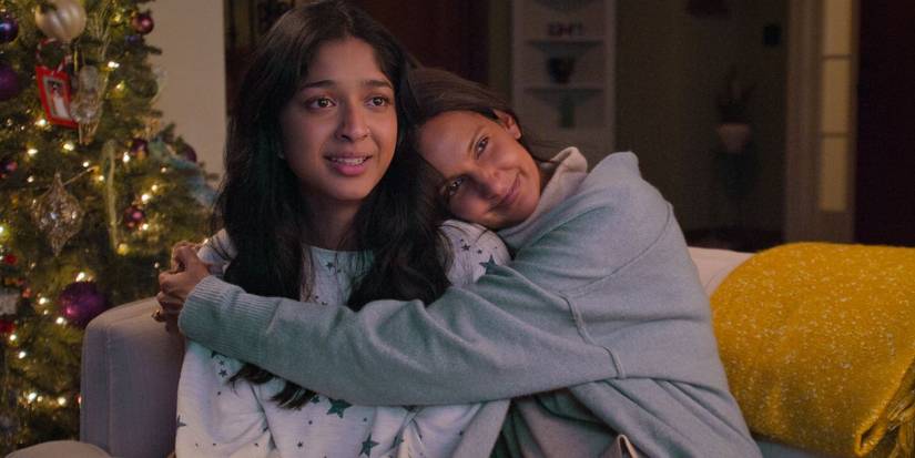 Nalini and Devi sharing a heartfelt moment while watching Mohan's videoclip