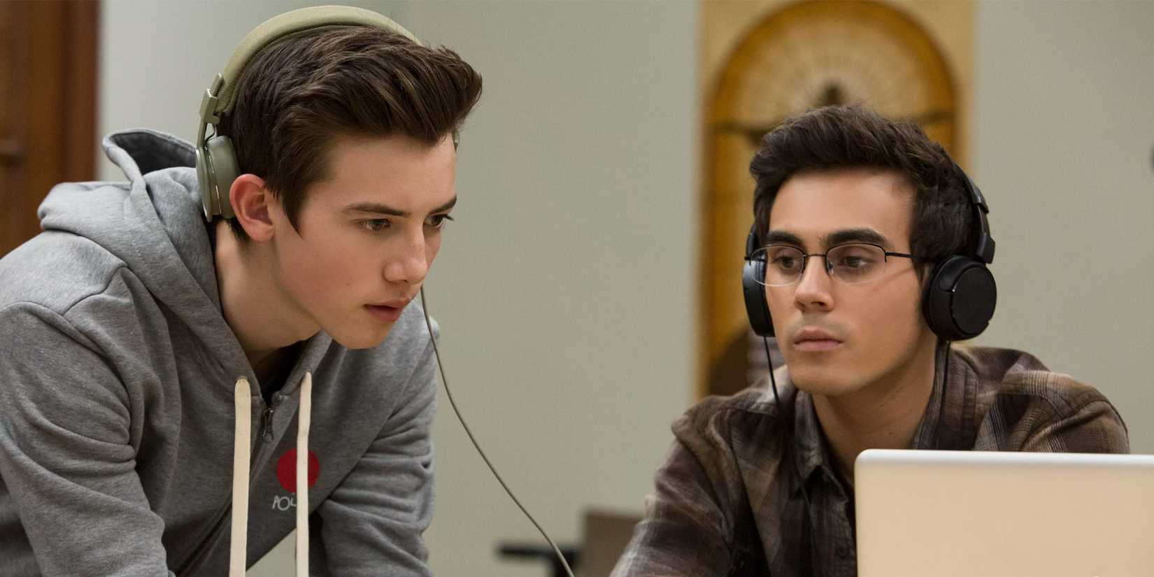 Tyler Alvarez as Peter Maldonado and Griffin Gluck as Sam Ecklund wearing headphones in American Vandal.