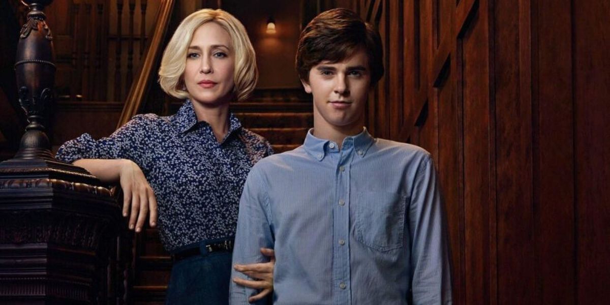 Vera Farmiga and Freddie Highmore standing on a set of stairs at the Bates Motel
