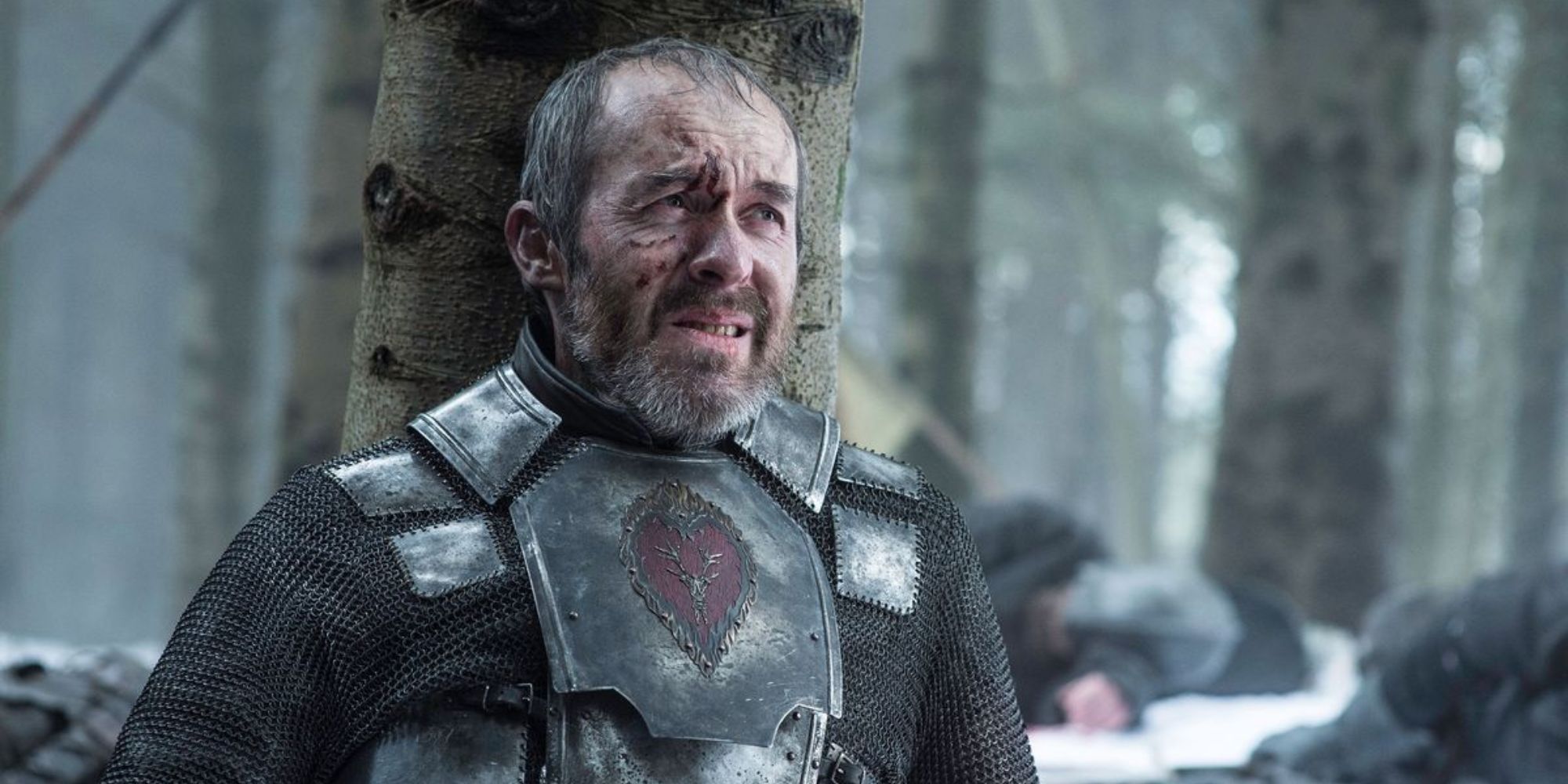 Stannis lies wounded against a tree amongst corpses