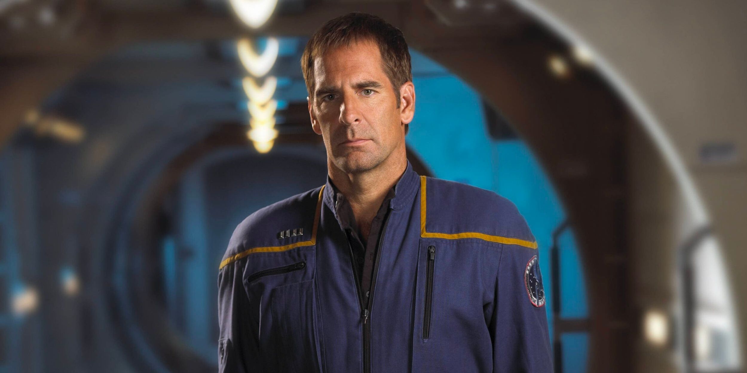 Captain Jonathan Archer (Scott Bakula) stands in a hallway on the USS Enterprise