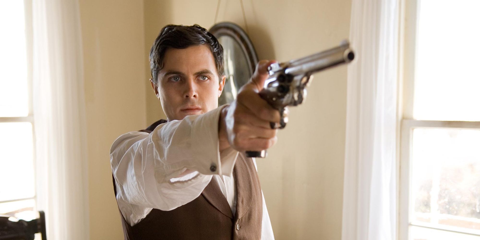 Casey Affleck pointing a gun at someone in 'The Assassination of Jesse James by the Coward Robert Ford' (2007)