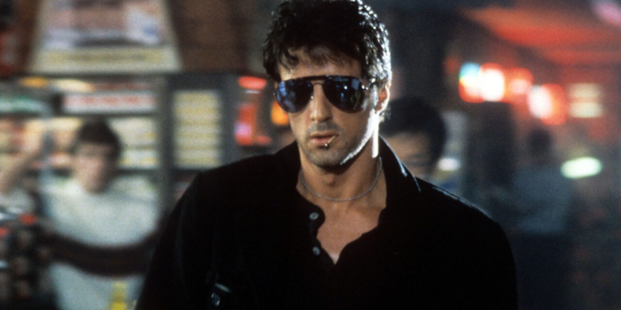 Sylvester Stallone as Cobra wears his shades indoors in Cobra.