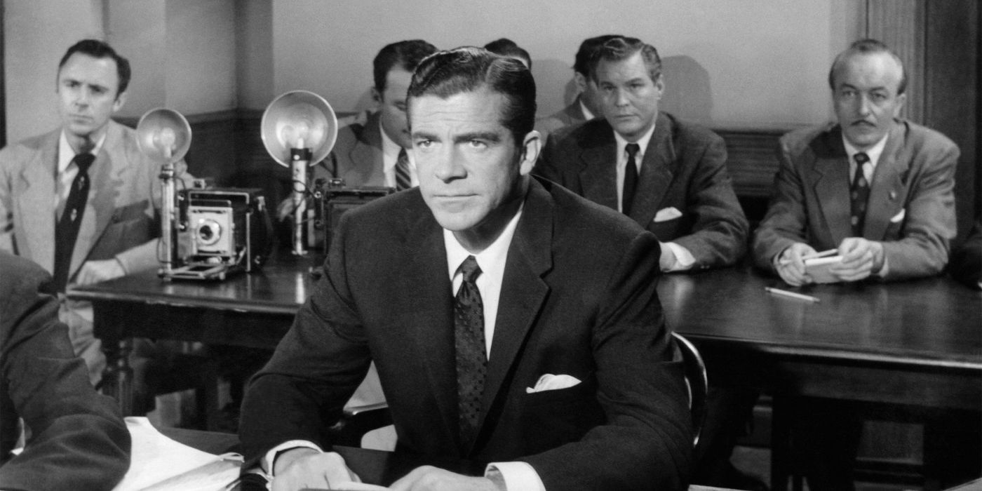 Dana Andrews sits at a courtroom table in Beyond a Reasonable Doubt