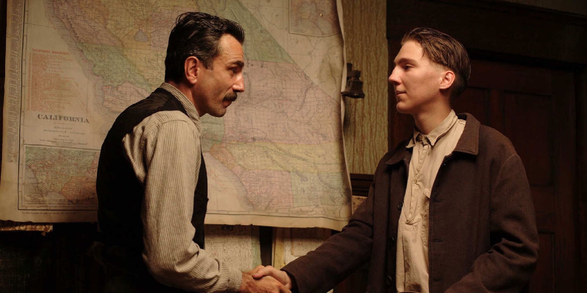 Daniel Day-Lewis and Paul Dano shaking hands in 'There Will Be Blood' (2007)