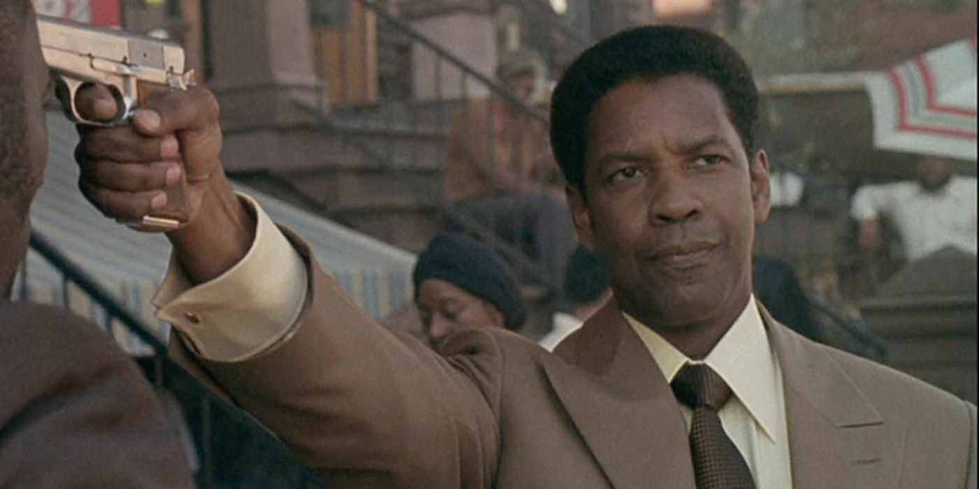 Frank Lucas pointing a gun at someone in 'American Gangster.' 