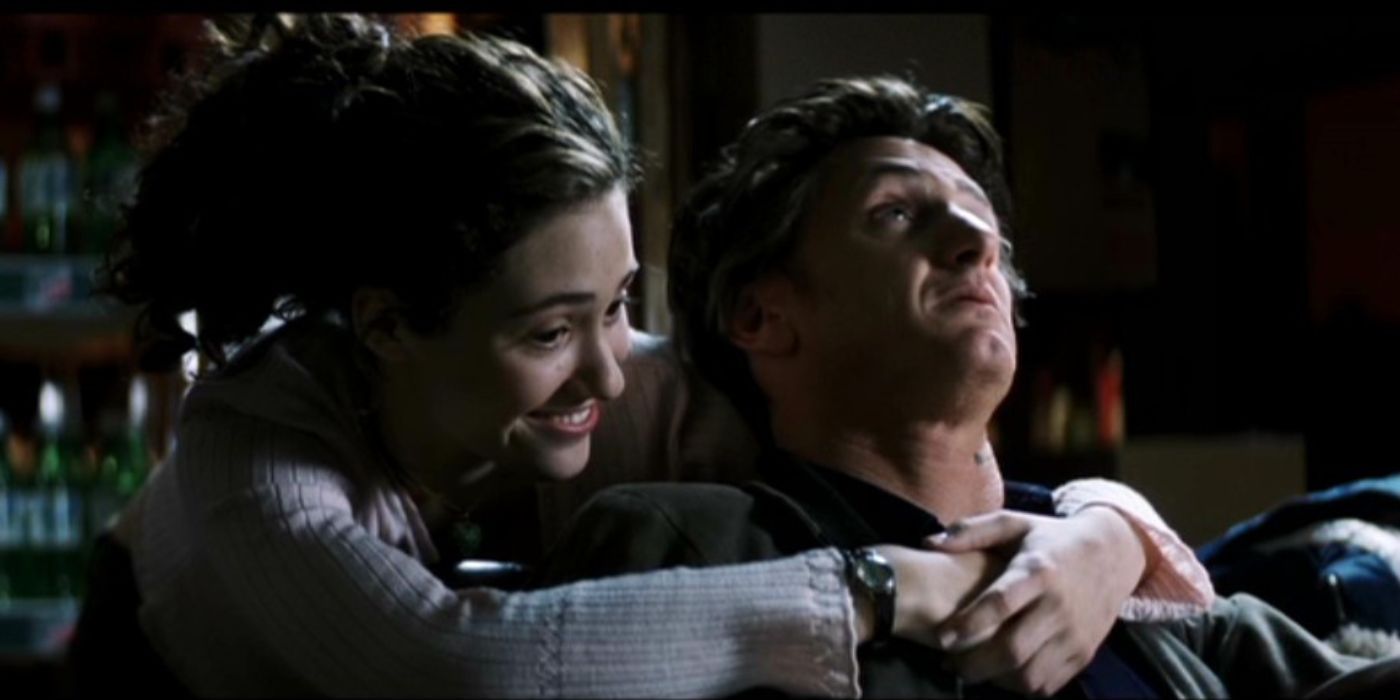 Emmy Rossum with her arms around Sean Penn in Mystic River