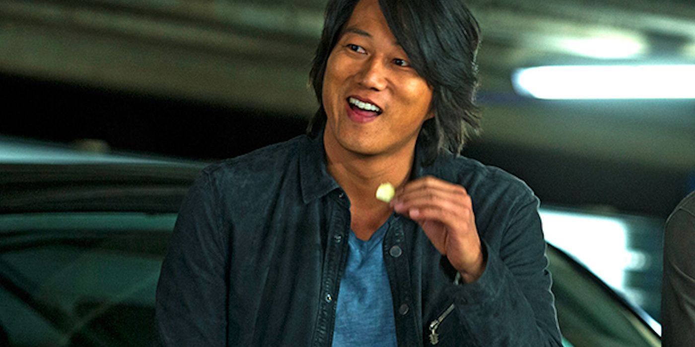 Sung Kang as Han smiling and eating in The Fast and the Furious: Tokyo Drift