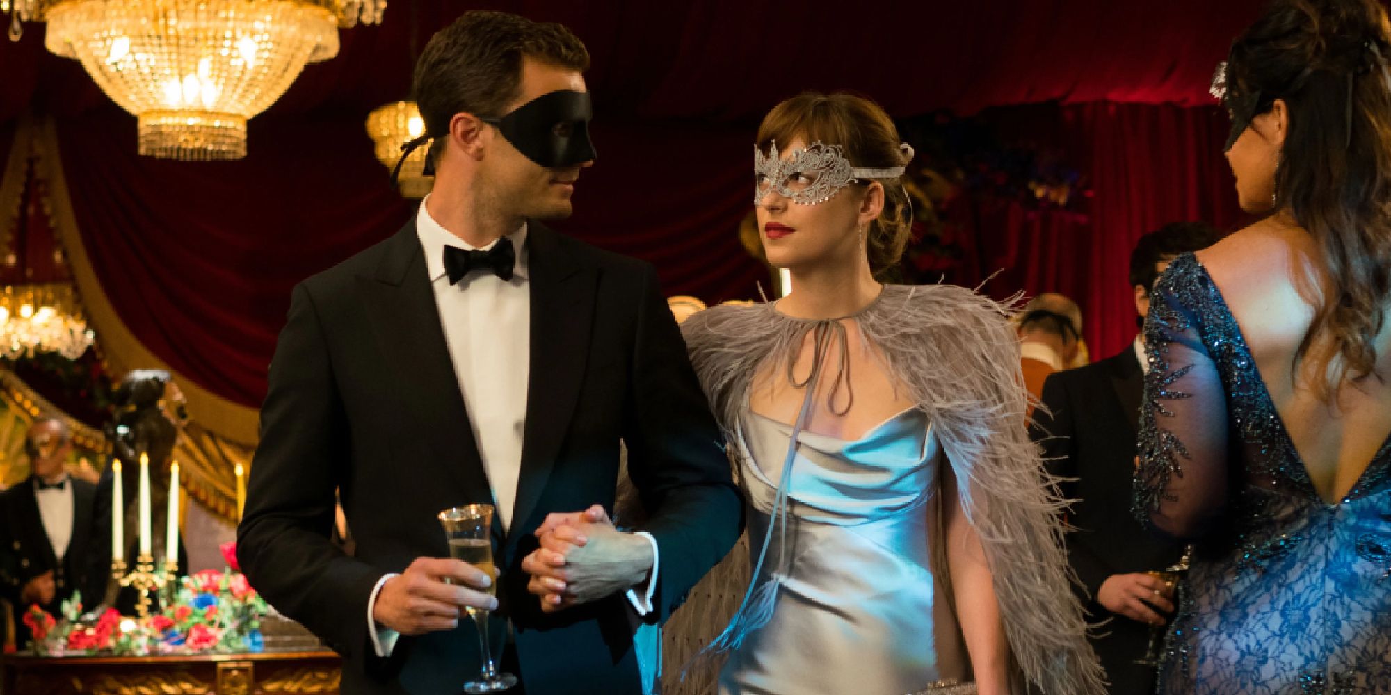 dakota johnson as anastasia steele and jamie dornan as christian grey wearing masquerade clothing inin fifty shades darker