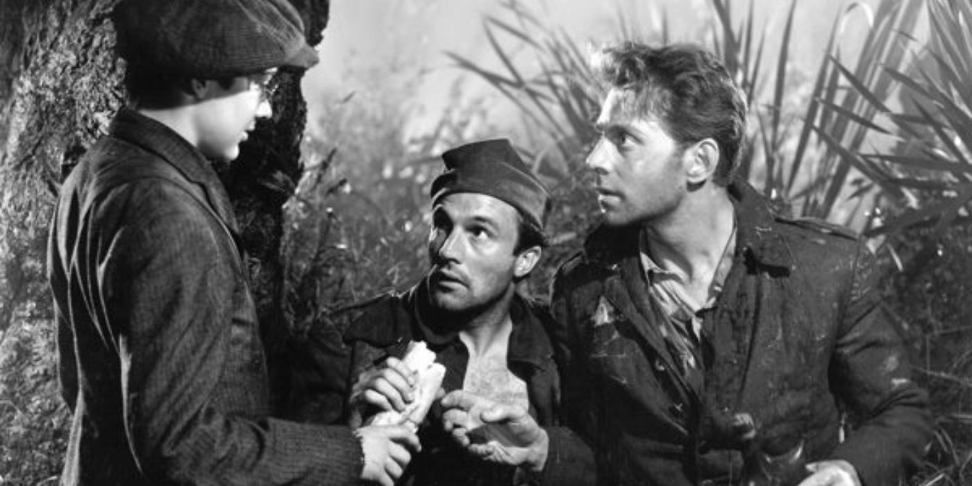 Gene Kelly and Jean-Pierre Aumont talking to a young man in the jungle in The Cross of Lorraine (1943)