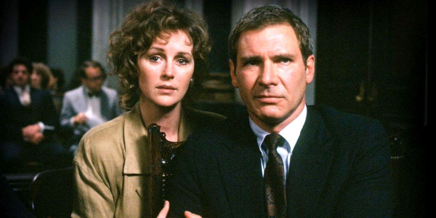 Harrison Ford and Bonnie Bedelia sitting together in a court room in Presumed Innocent (1990)