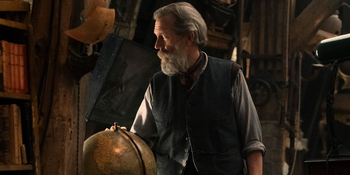 Hugh Laurie looks left near a globe in Netflix's The Light We Can't See