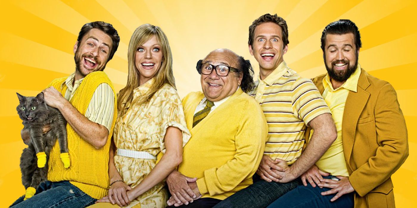 The cast of It's Always Sunny in Philadelphia smiling in a ridiculous way as they pose for a photo