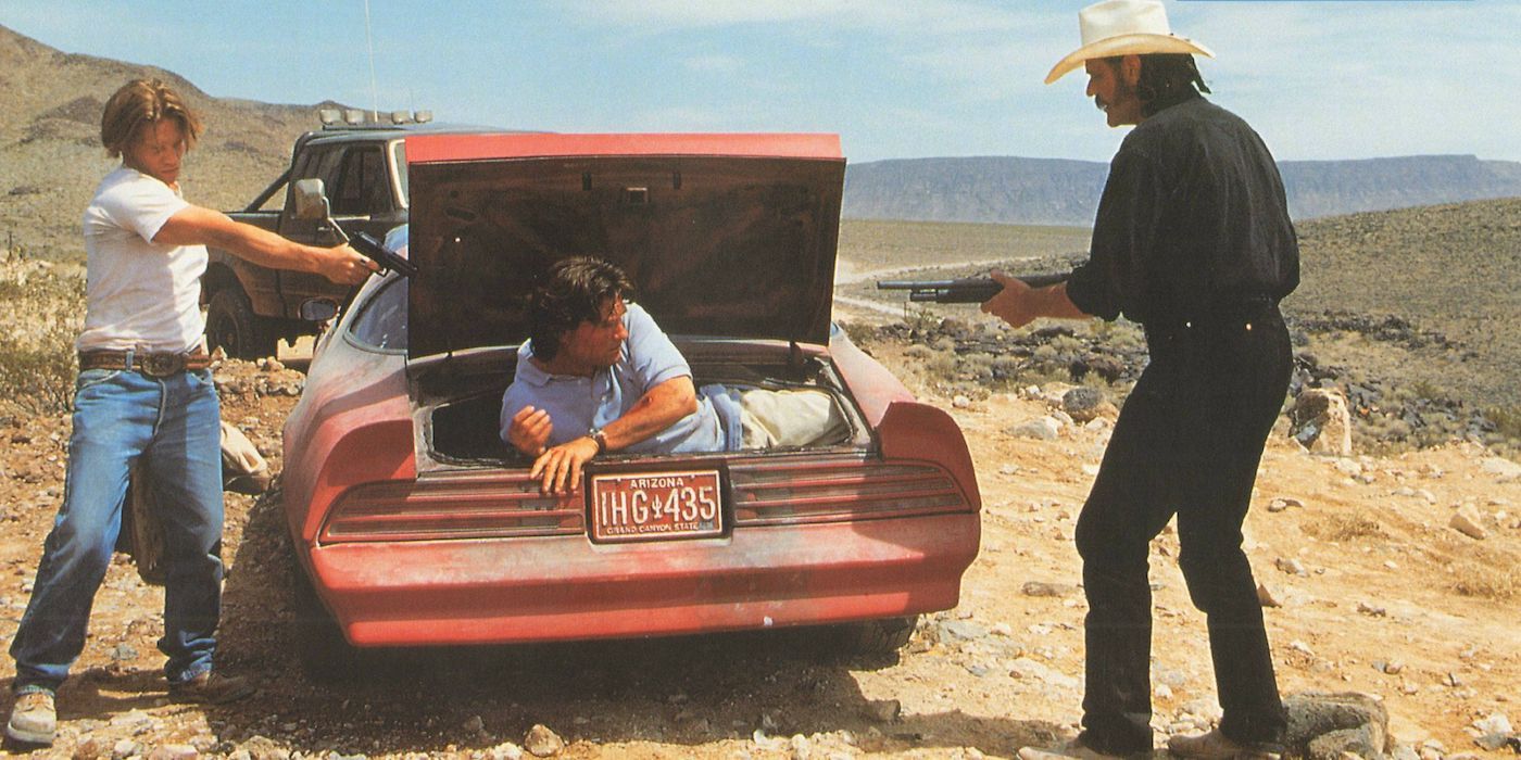 Jack Noseworthy and M.C. GaJack Noseworthy as Billy and M.C. Gainey as Earl point their guns at Kurt Russell as Jeff Taylor in Breakdowniney point their guns atKurt Russell in Breakdown (1997)