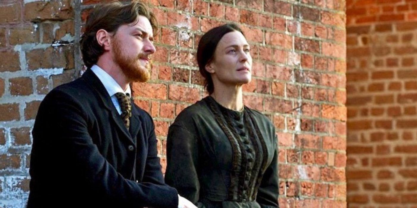 James McAvoy sitting next to Robin Wright outside a brick building in The Conspirator (2010)