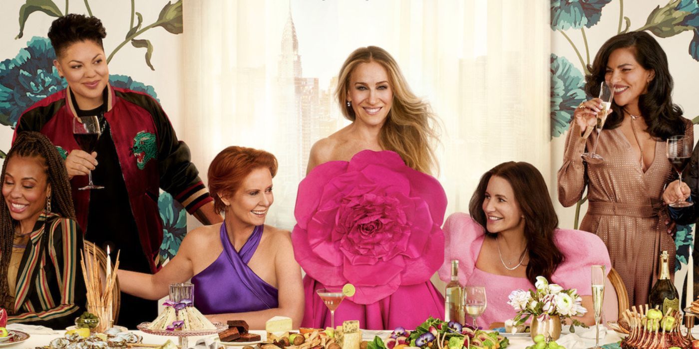 Sarah Jessica Parker as Carrie, Cynthia Nixon as Miranda, and Kristin Davis as Charlotte sitting at an elegant dinner table smiling at each other in And Just Like That Season 2
