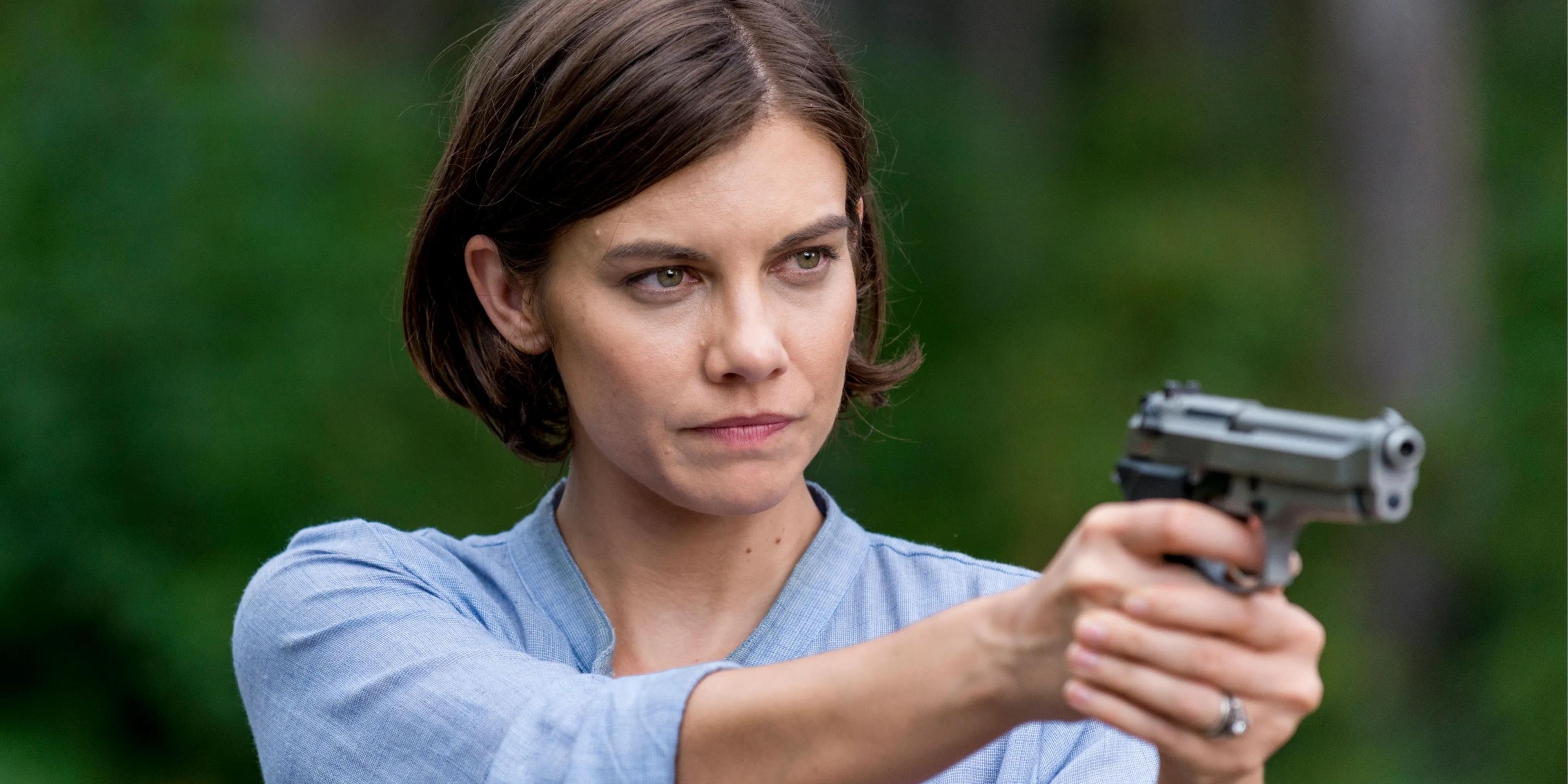 Lauren Cohan as Maggie in The Walking Dead with short hair holding a gun