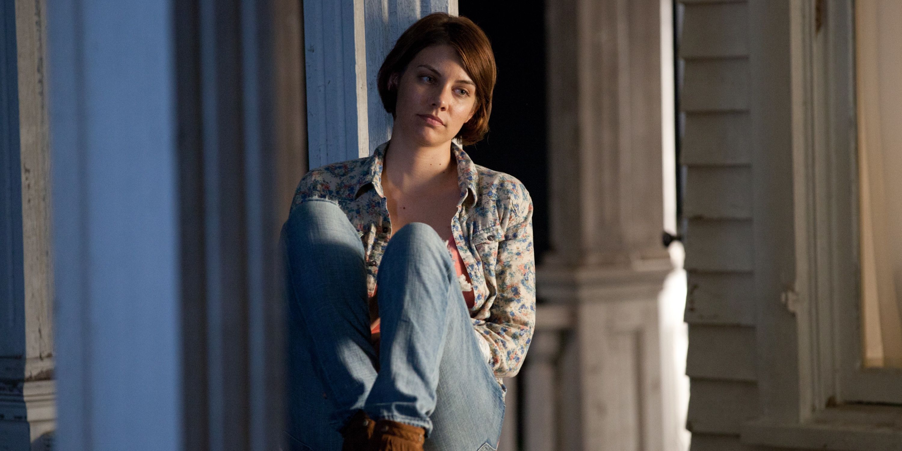 Lauren Cohan as Maggie sitting on a railing in The Walking Dead