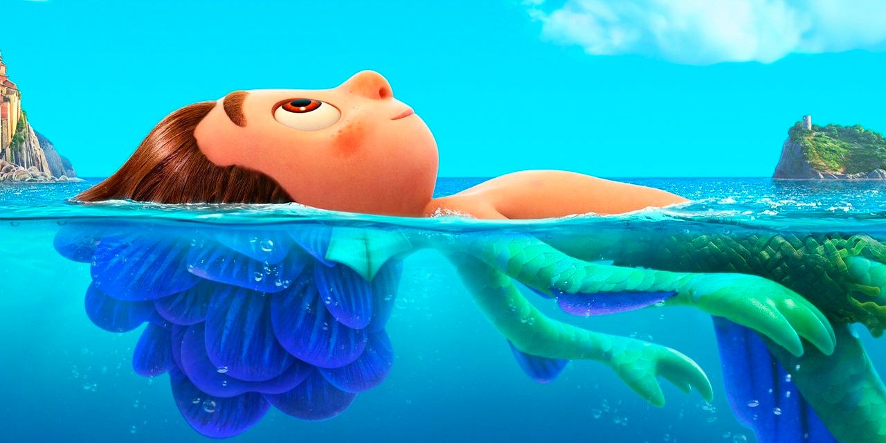 A young boy who transforms into a sea monster under water floats on the ocean's surface in the animated Pixar movie 'Luca'.
