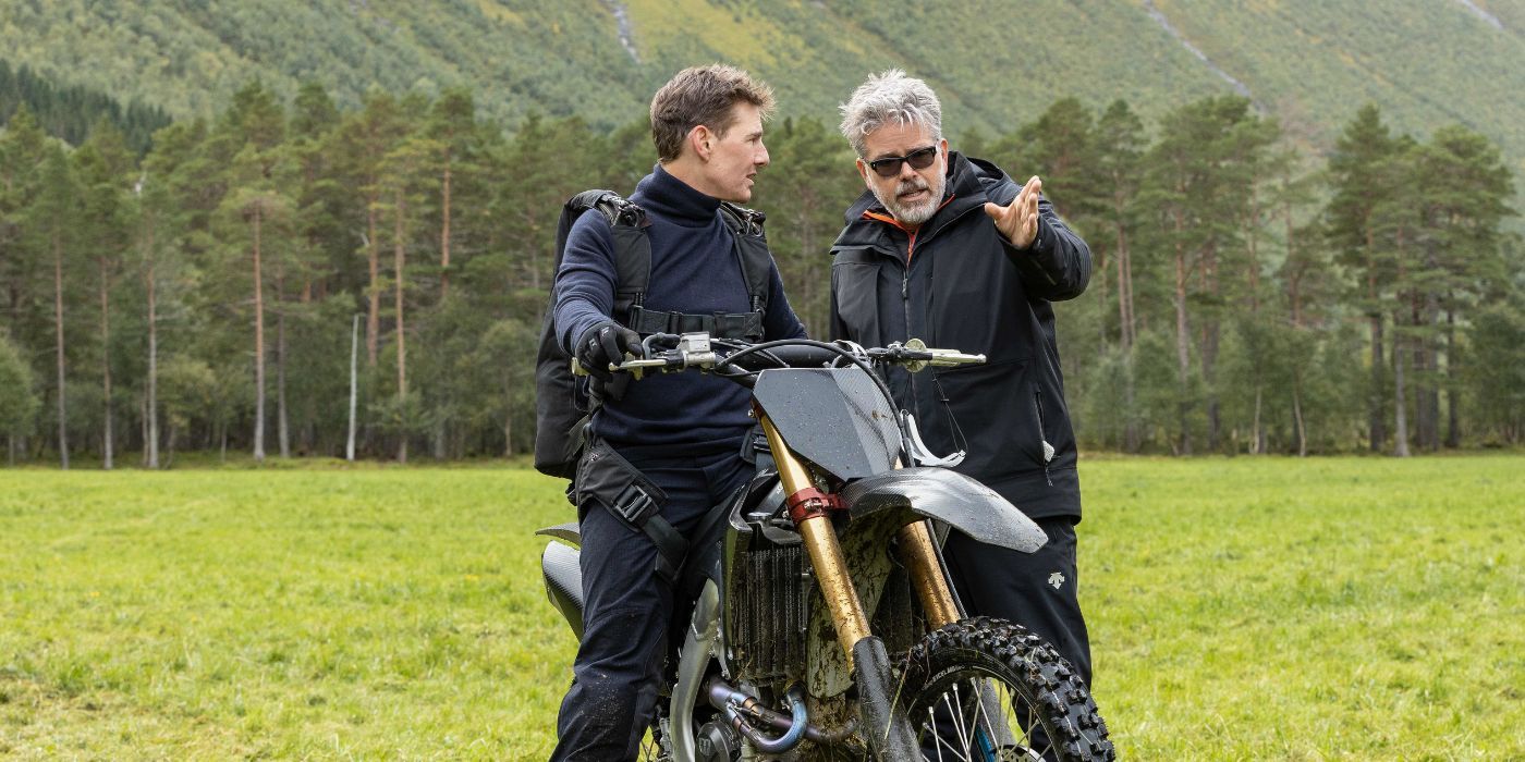 Tom Cruise rides a motorcycle next to Christopher McQuarrie