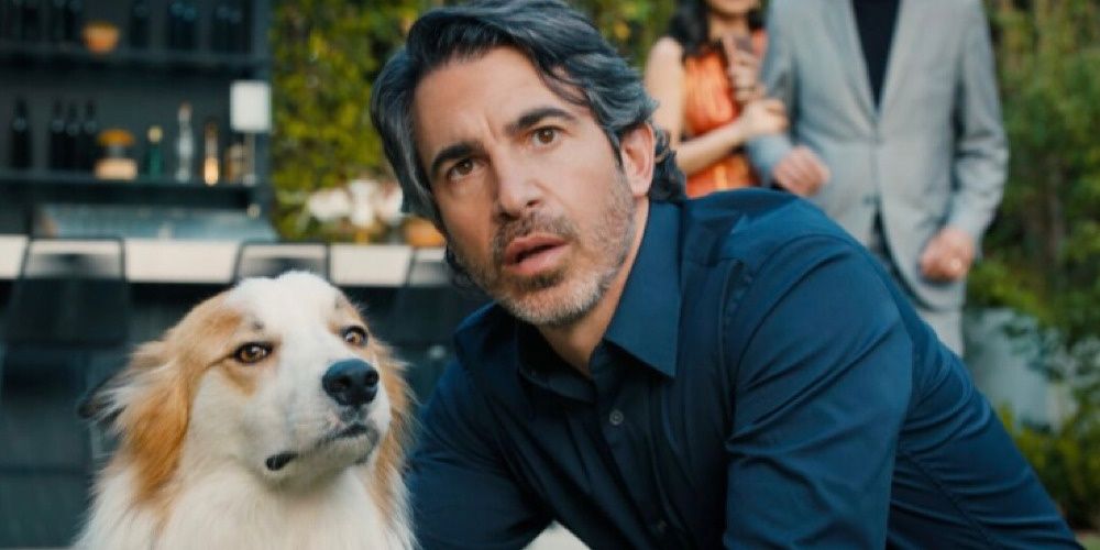 Chris Messina as Nathan Bartlett kneeling with a dog in Based on a True Story. 