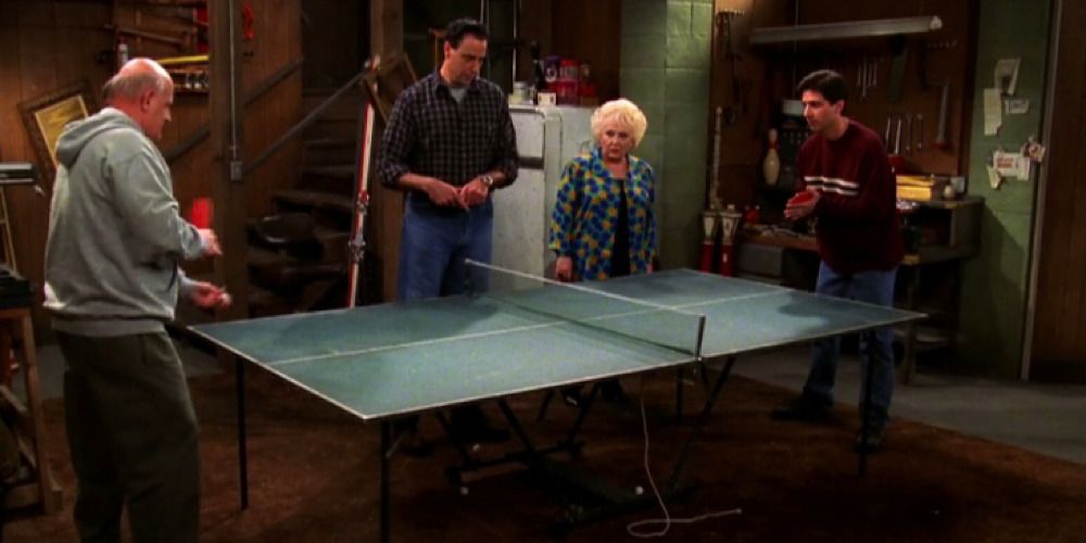 Frank, Robert, Marie and Ray around a ping pong table.