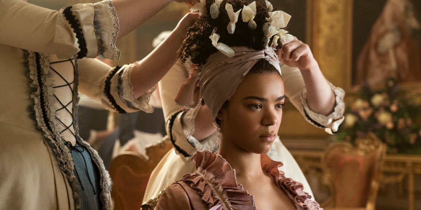 India Amarteifio as Queen Charlotte, getting her hair done by servants in Episode 102 of 'Queen Charlotte: A Bridgerton Story.' 