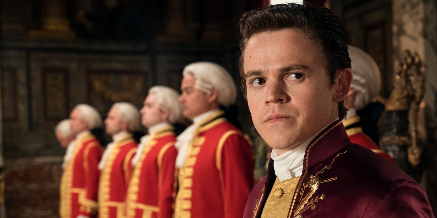 Sam Clemmett as Brimsley, standing with a line of servants in Episode 102 of 'Queen Charlotte: A Bridgerton Story.'