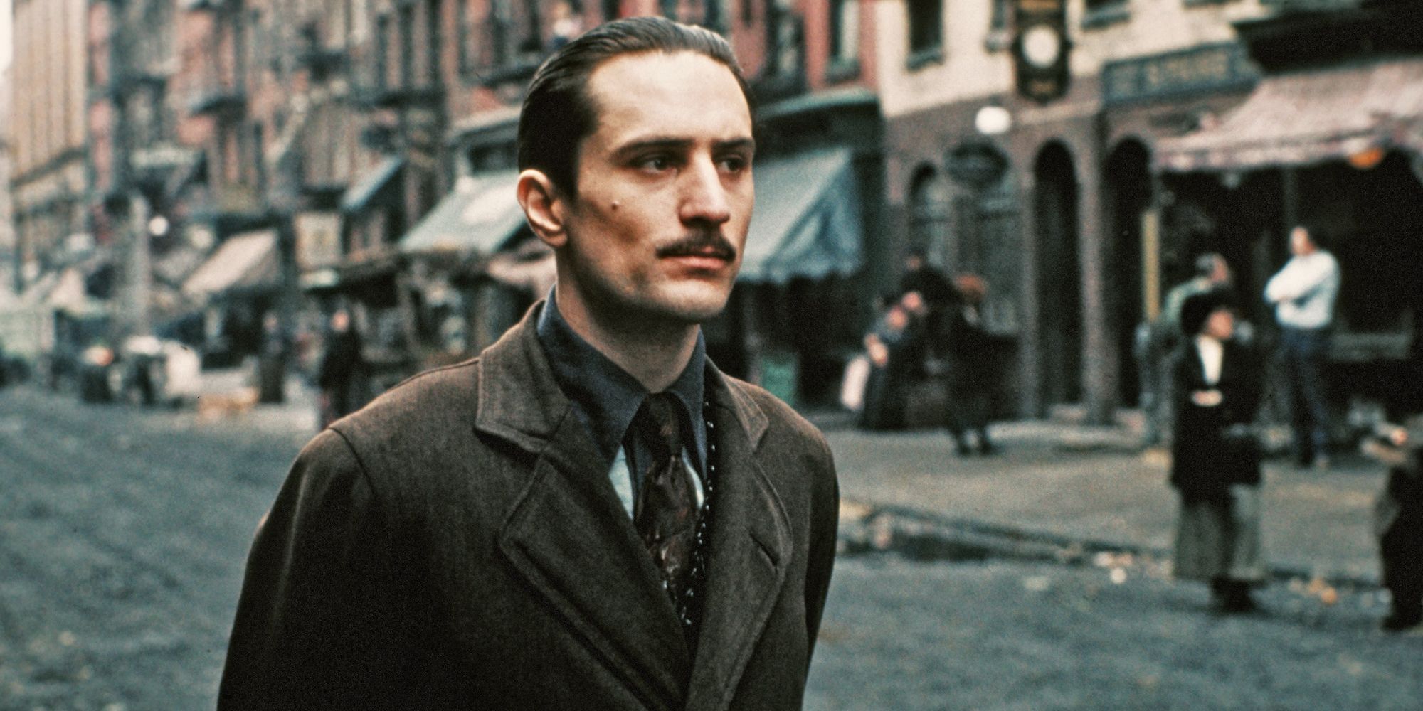 Robert De Niro as young Vito Corleone standing on the street in The Godfather Part II.