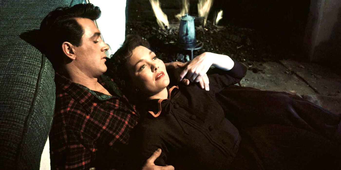 Rock Hudson lying by a fire with Jane Wyman in All That Heaven Allows (1955)