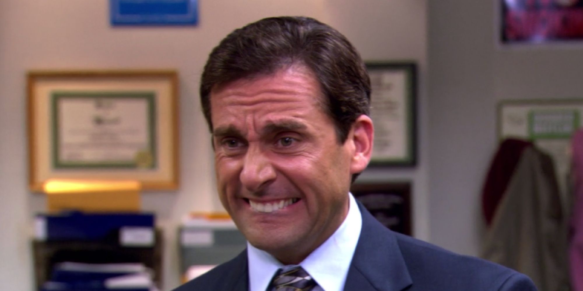 Steve Carell as Michael Scott making a cringe face in The Office