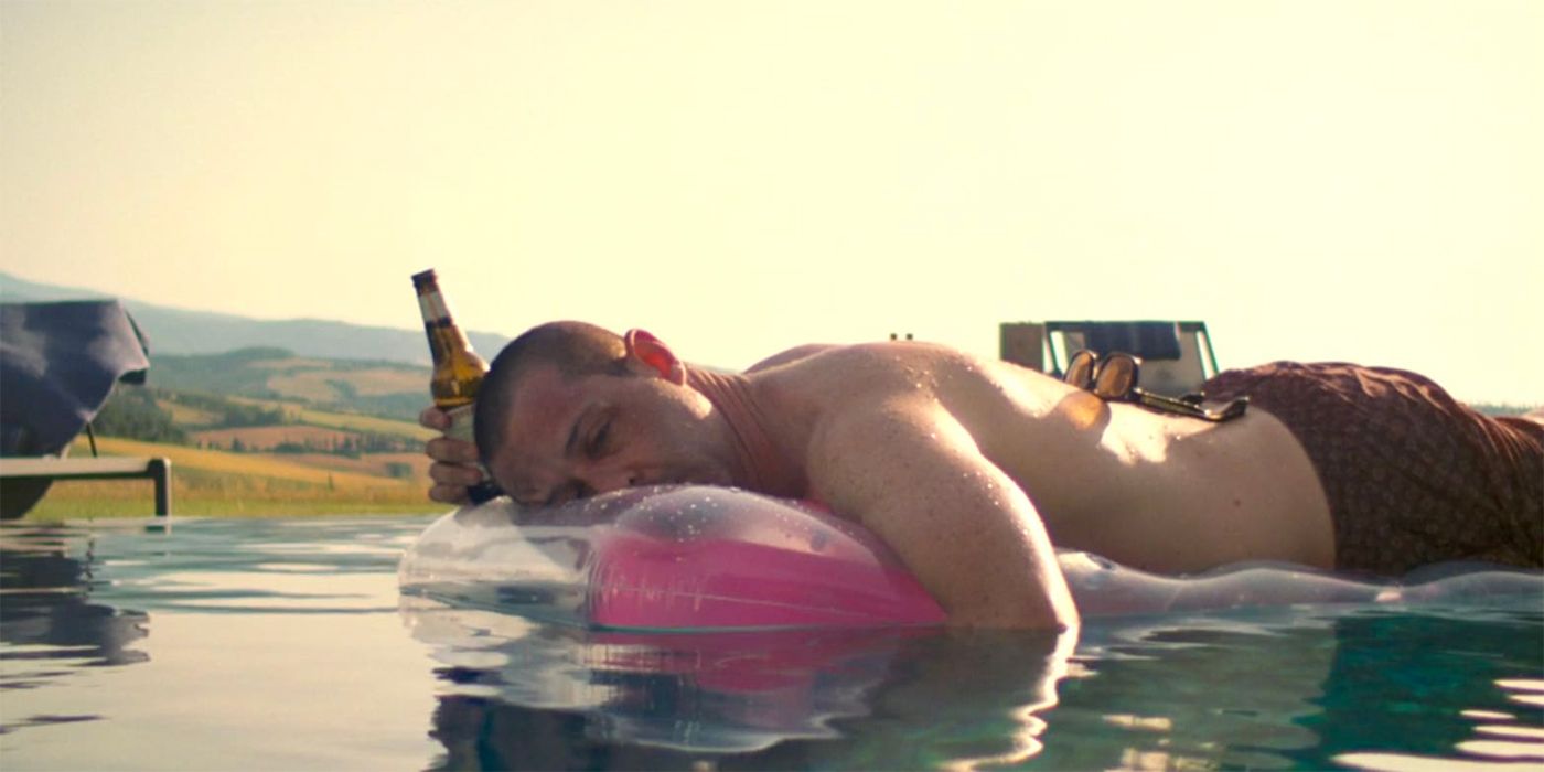 Kendall Roy lying on a floaty at a pool in Succession Season 3