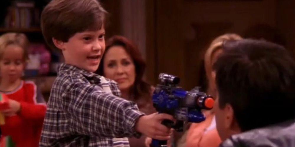 Spencer pointing a toy gun at Ray. 