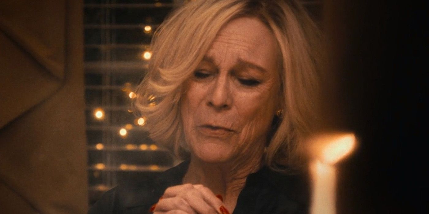Jamie Lee Curtis as Donna from The Bear at the dinner table looking sad and saying grace