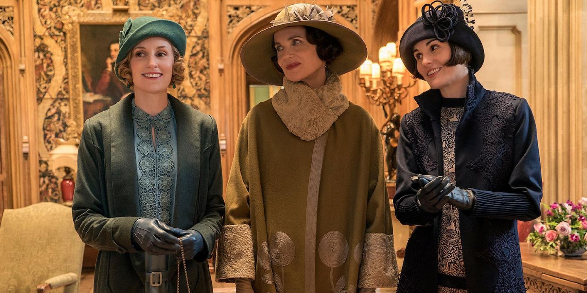 Elizabeth McGovern, Michelle Dockery, and Laura Carmichael all smiling in Downton Abbey.