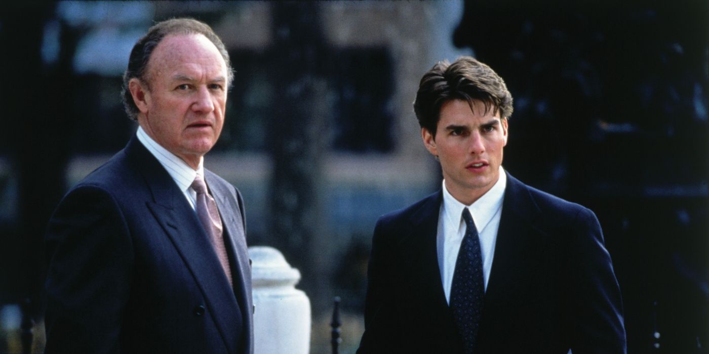 Gene Hackman as Avery and Tom Cruise as Mitch standing together outside in 'The Firm.' 