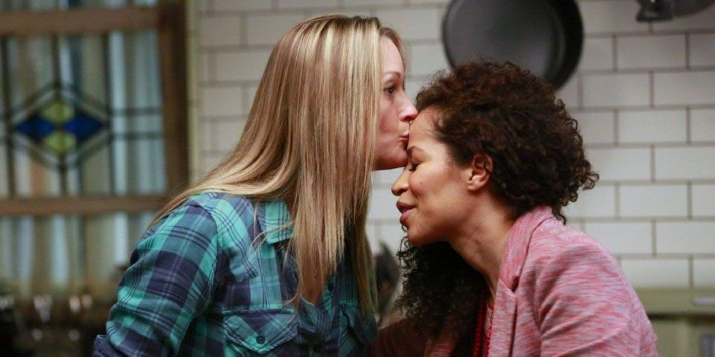 Teri Polo as Stef kissing Sherri Saum's Lena on the forehead in 'The Fosters.' 
