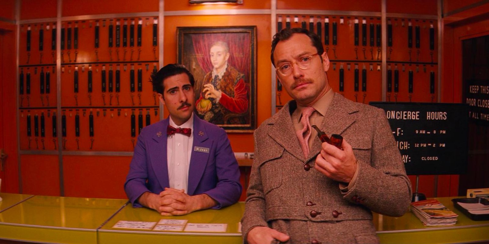 M. Jean, a concierge at the Grand Budapest Hotel, talks to a guest about the hotel's owner.