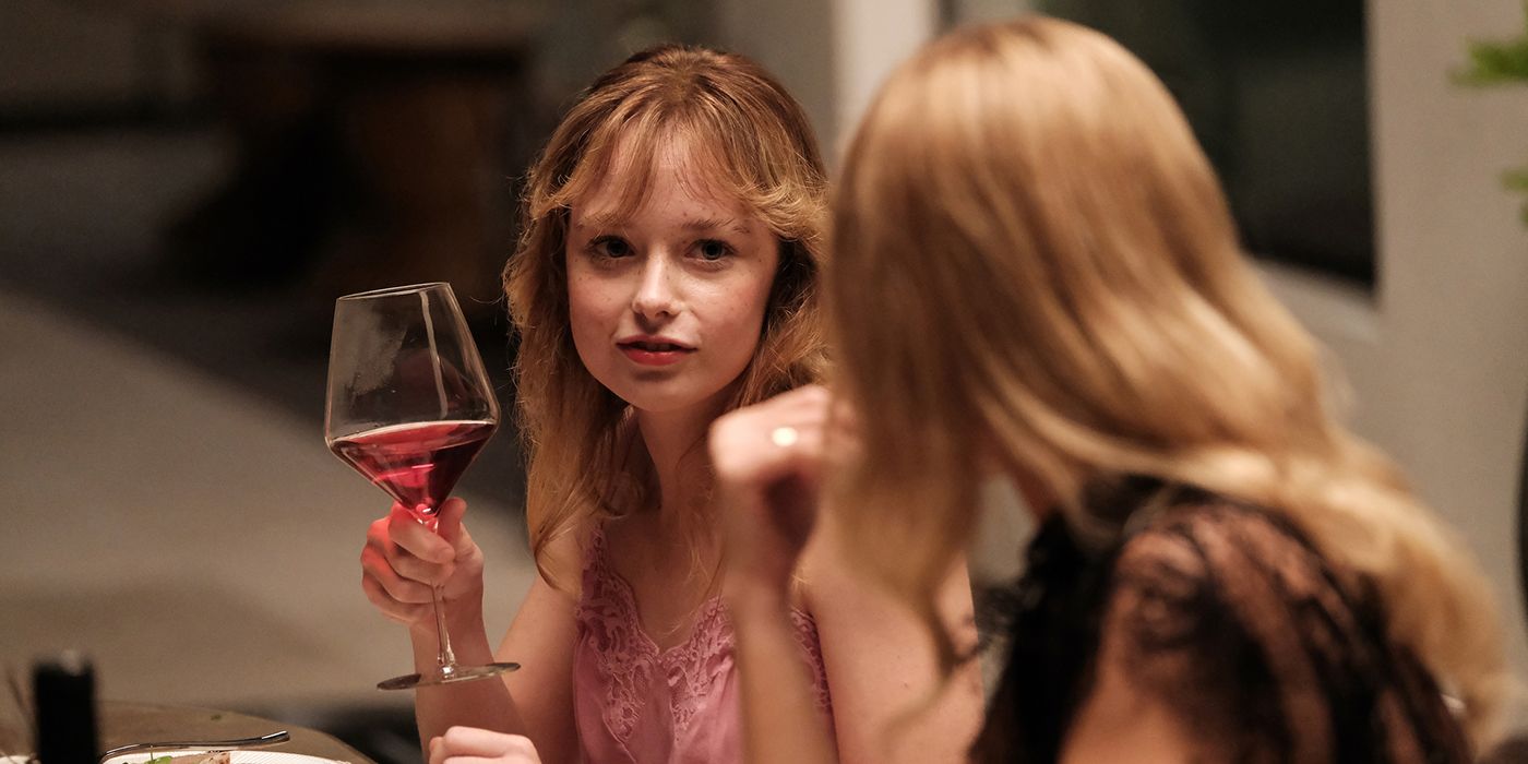 Suzanna Son holds up a glass of wine in The Idol