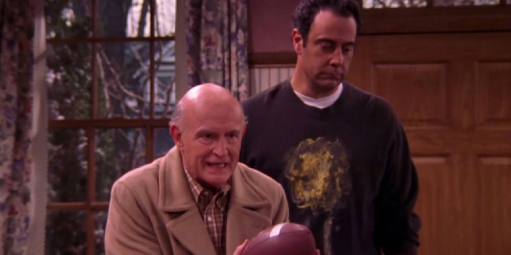 Frank holding football on Everybody Loves Raymond. 