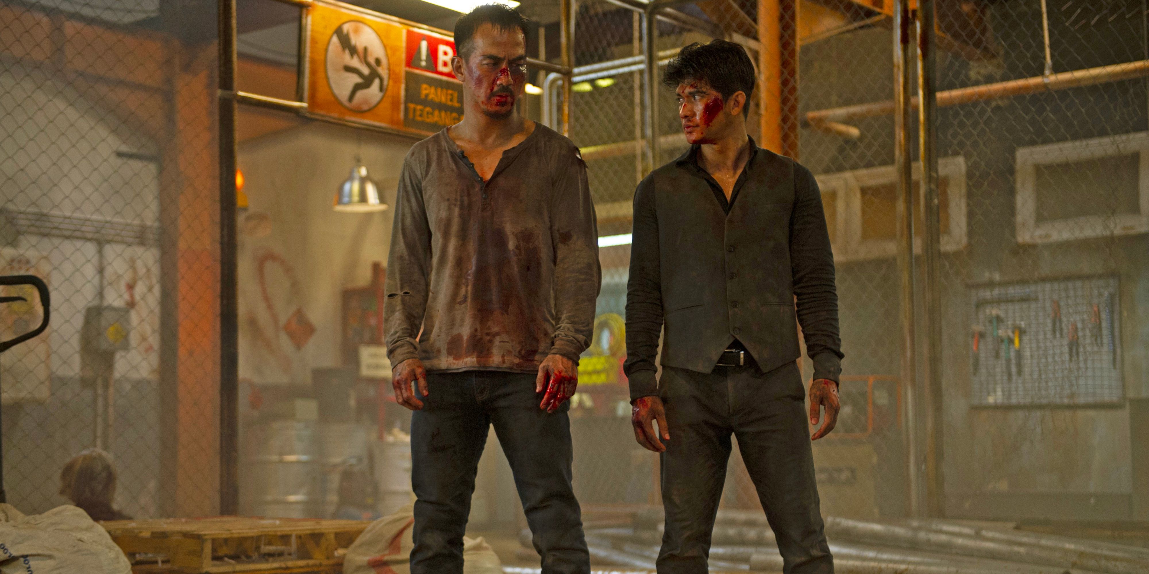 Two rival fighters for triad gangs look to each other as they stand bloodied after a brawl.