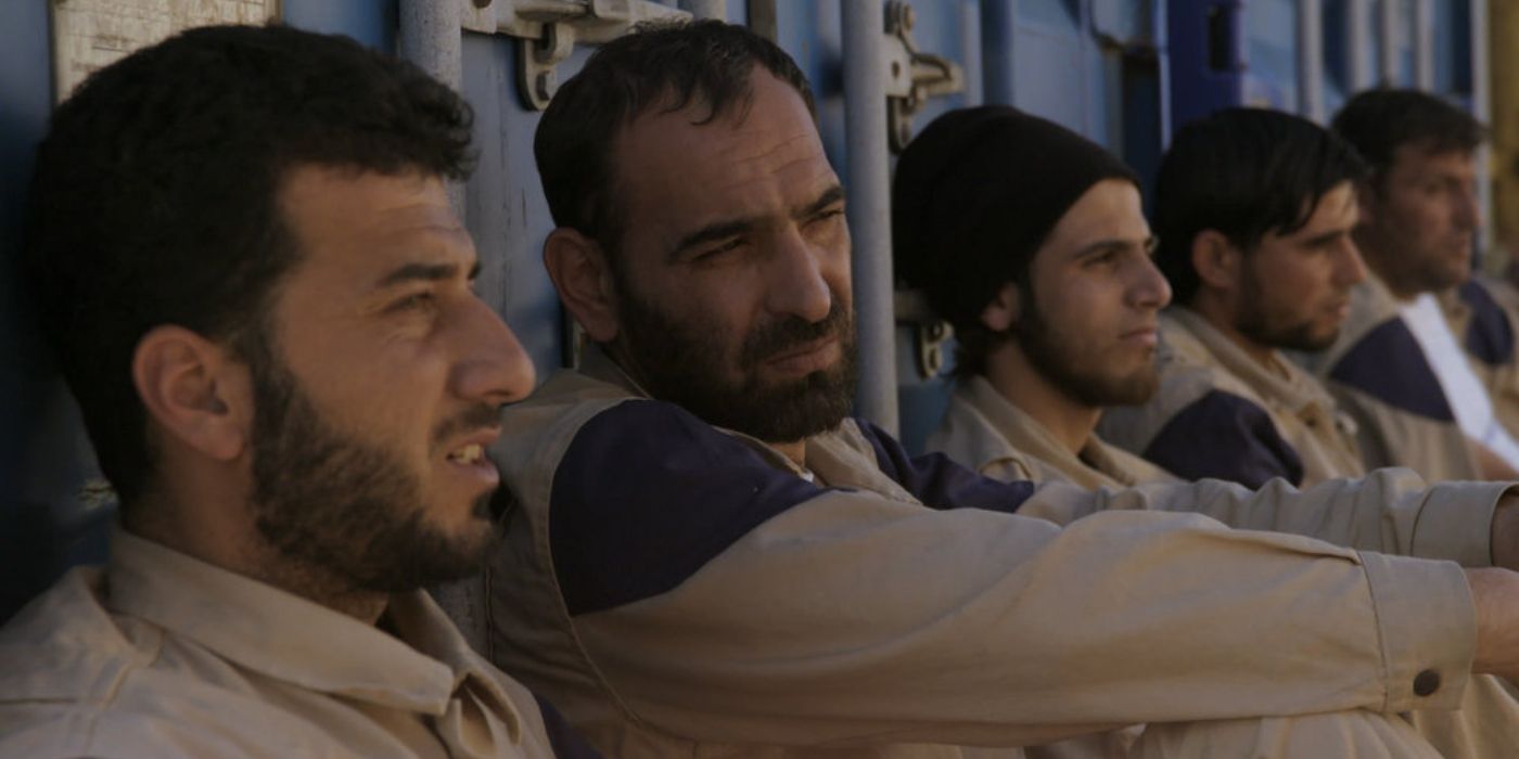 Members of the White Helmets lined up against a wall in the documentary, 'The White Helmets.'