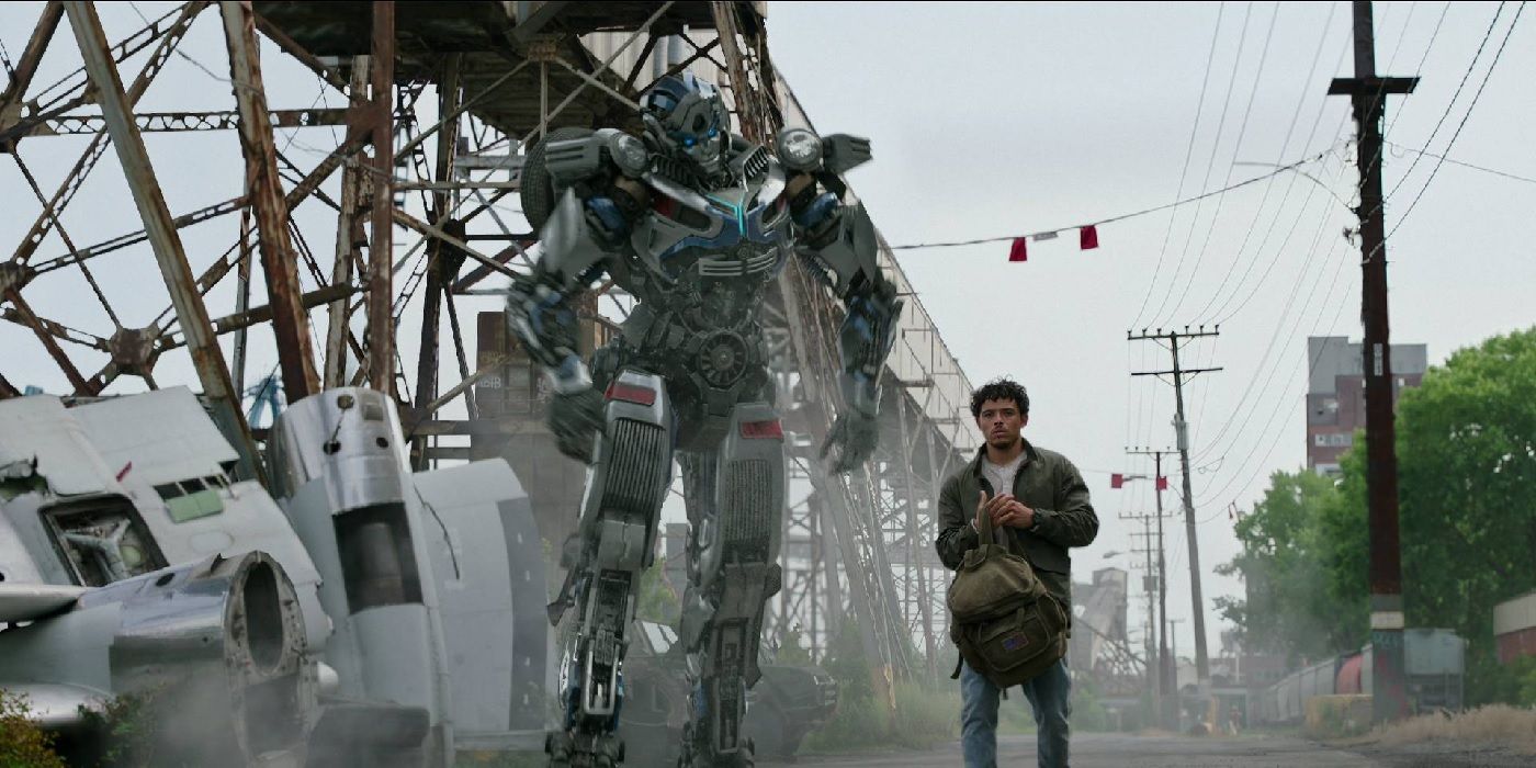 Mirage (Peter Davidson) and Noah Diaz (Anthony Ramos) walk together in Transformers: Rise of the Beast