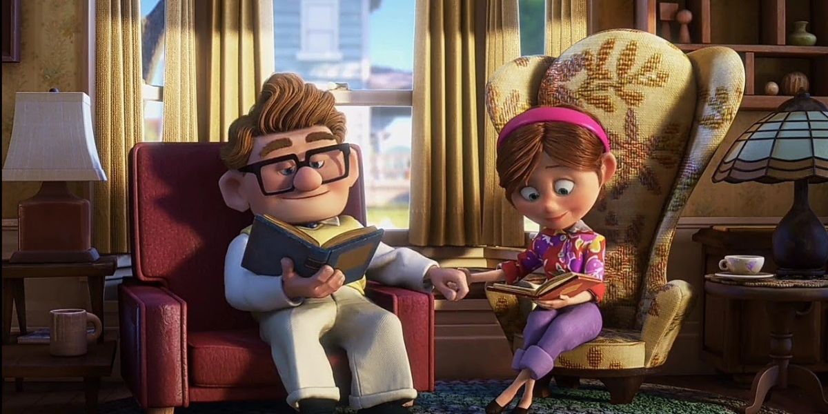 Carl and Ellie holding hands as they read in Pixar's Up