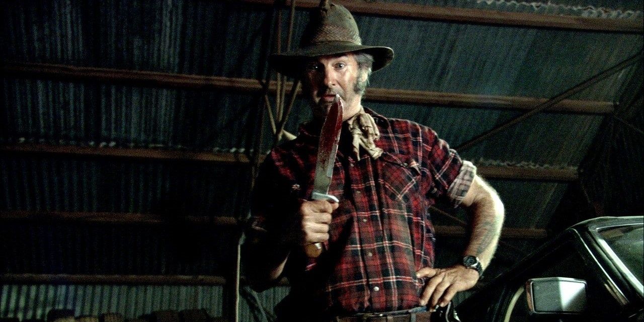 Mick Taylor in 'Wolf Creek' holds a knife