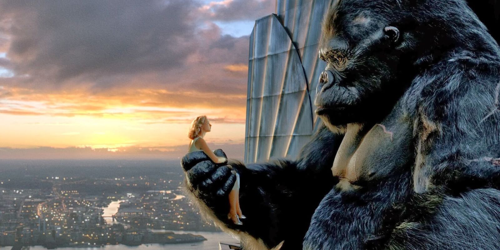 A woman is held in the hand of a giant ape atop a building