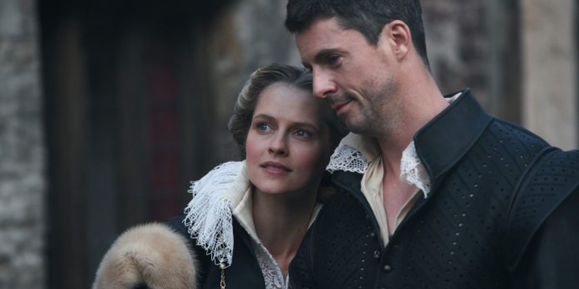 Matthew Goode and Teresa Palmer as Matthew Clairmont and Diana Bishop leaning their heads together lovingly in A Discovery of Witches Season 2