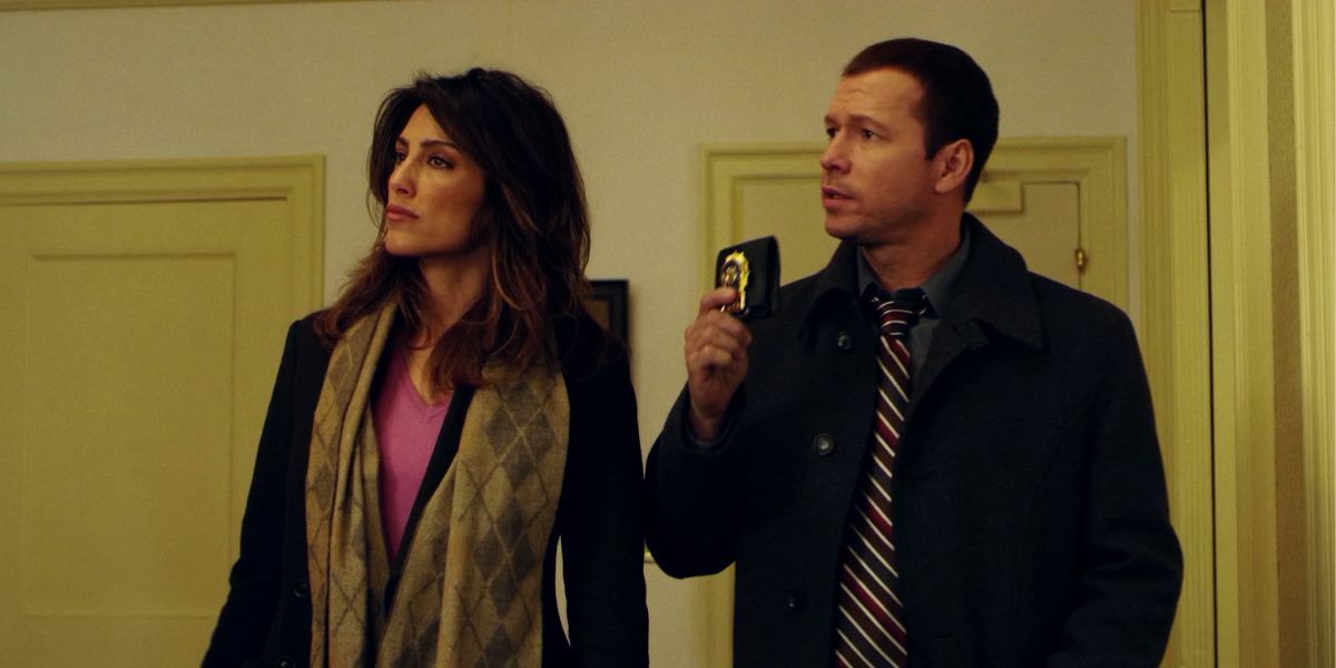 Jennifer Esposito and Donnie Wahlberg as Jackie and Danny, Danny showing his badge, on Blue Bloods